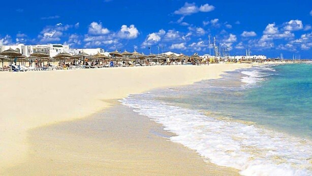 A beach with white buildings and umbrellas along the shore. - Zenon Hotel Djerba (Mezraia)
