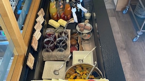A buffet with various food items, including cheeses, meats, fruits, and condiments. - Pension Widmann (Moso in Passiria)