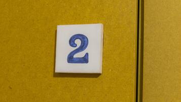 A white square with the number 2 in blue on a yellow background.