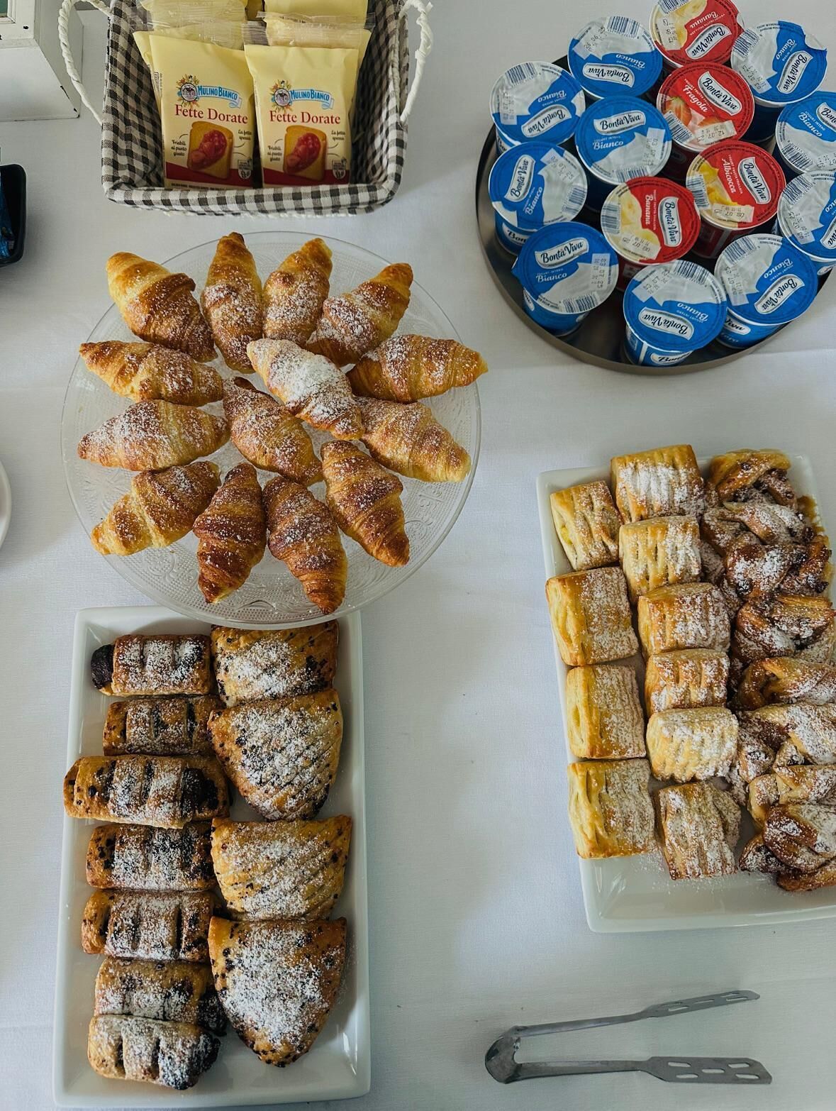 A table with various pastries and dairy products.