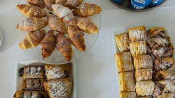 A table with various pastries and dairy products.