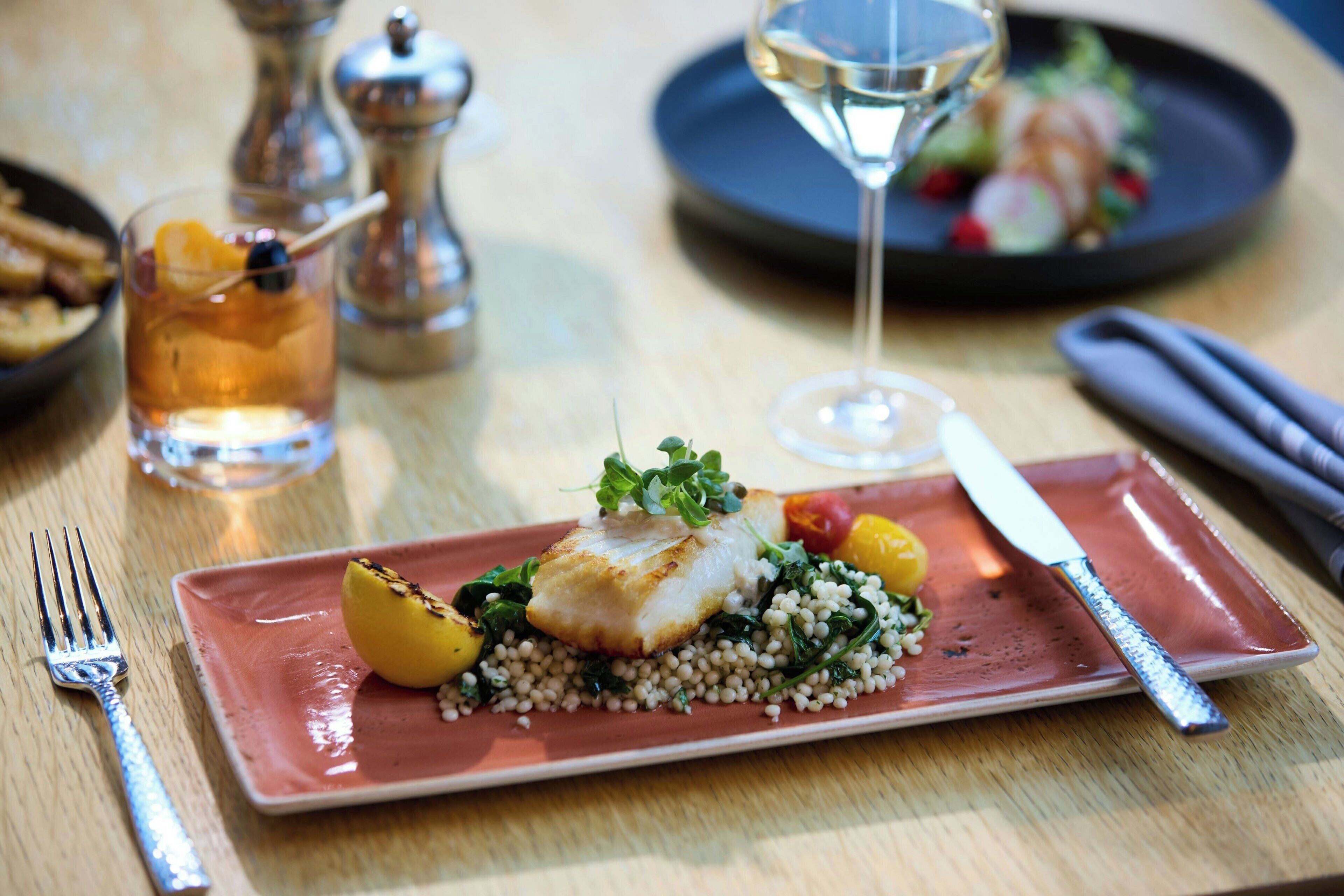 A plate of food with a fork and knife on a table.