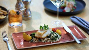 A plate of food with a fork and knife on a table.