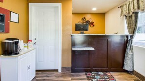 A compact kitchen with a coffee maker, a small refrigerator, and a microwave on the counter. - Rodeway Inn Middleboro - Plymouth (Middleborough)