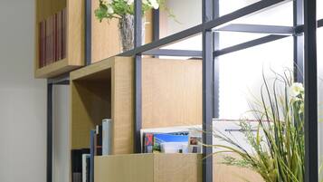 A multi-tiered wooden bookshelf with books and decorative items.
