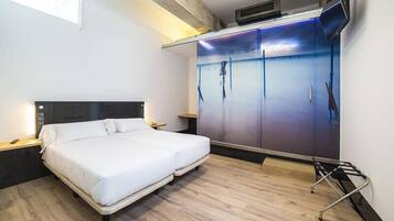 A modern bedroom with a bed, a wardrobe, and a TV.