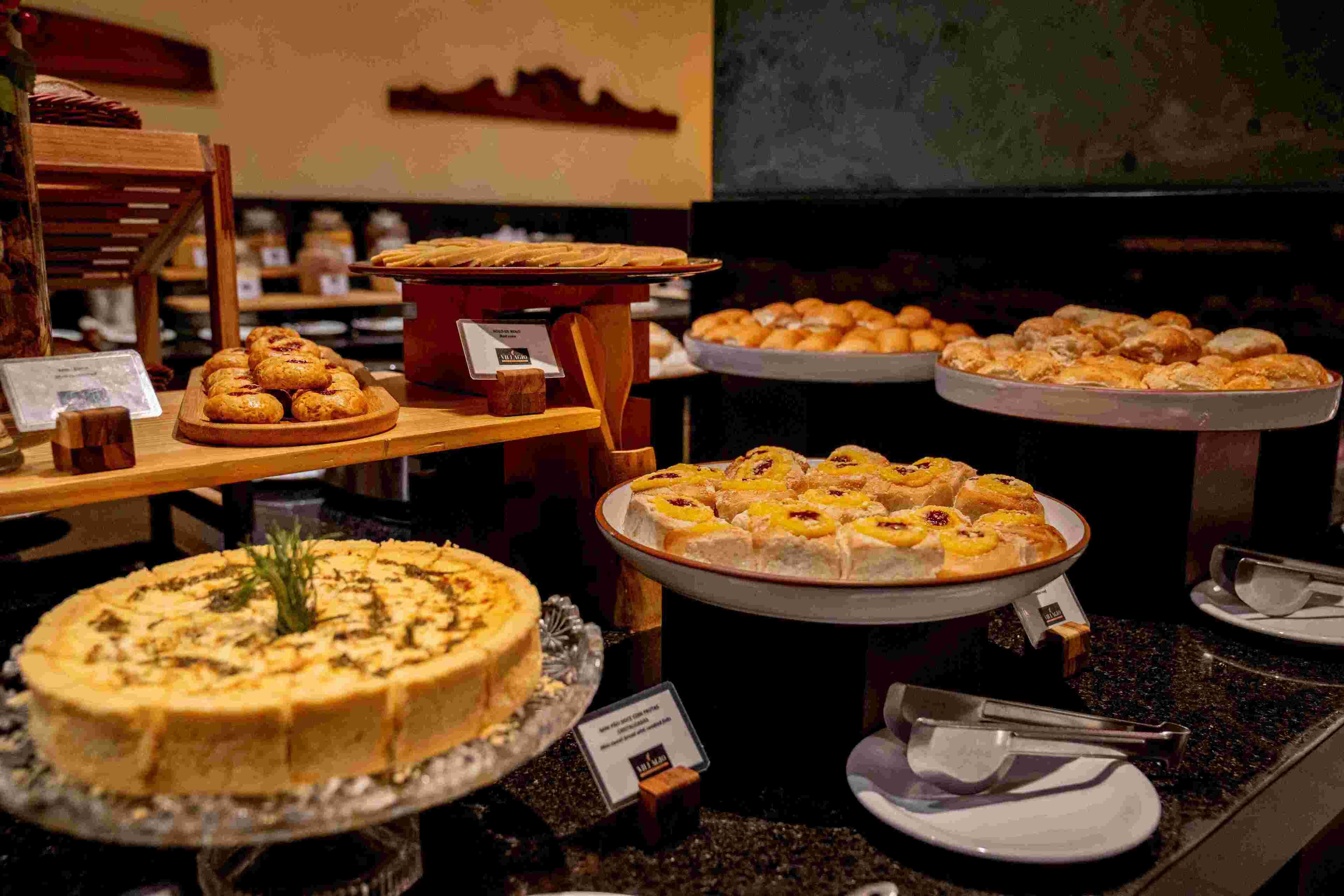 A buffet with various desserts including cakes and pastries.