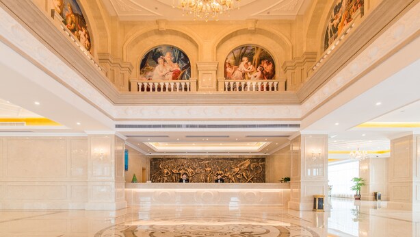 A grand lobby with a high ceiling, ornate chandeliers, and classical paintings. - Royal International Hotel Disneyland and Wild Animal Park Branch (Shanghai)