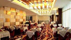 A spacious dining area with tables set for multiple guests, a patterned carpet, and a modern ceiling design. - Chengdu Gaoyi Hotel (Chengdu)