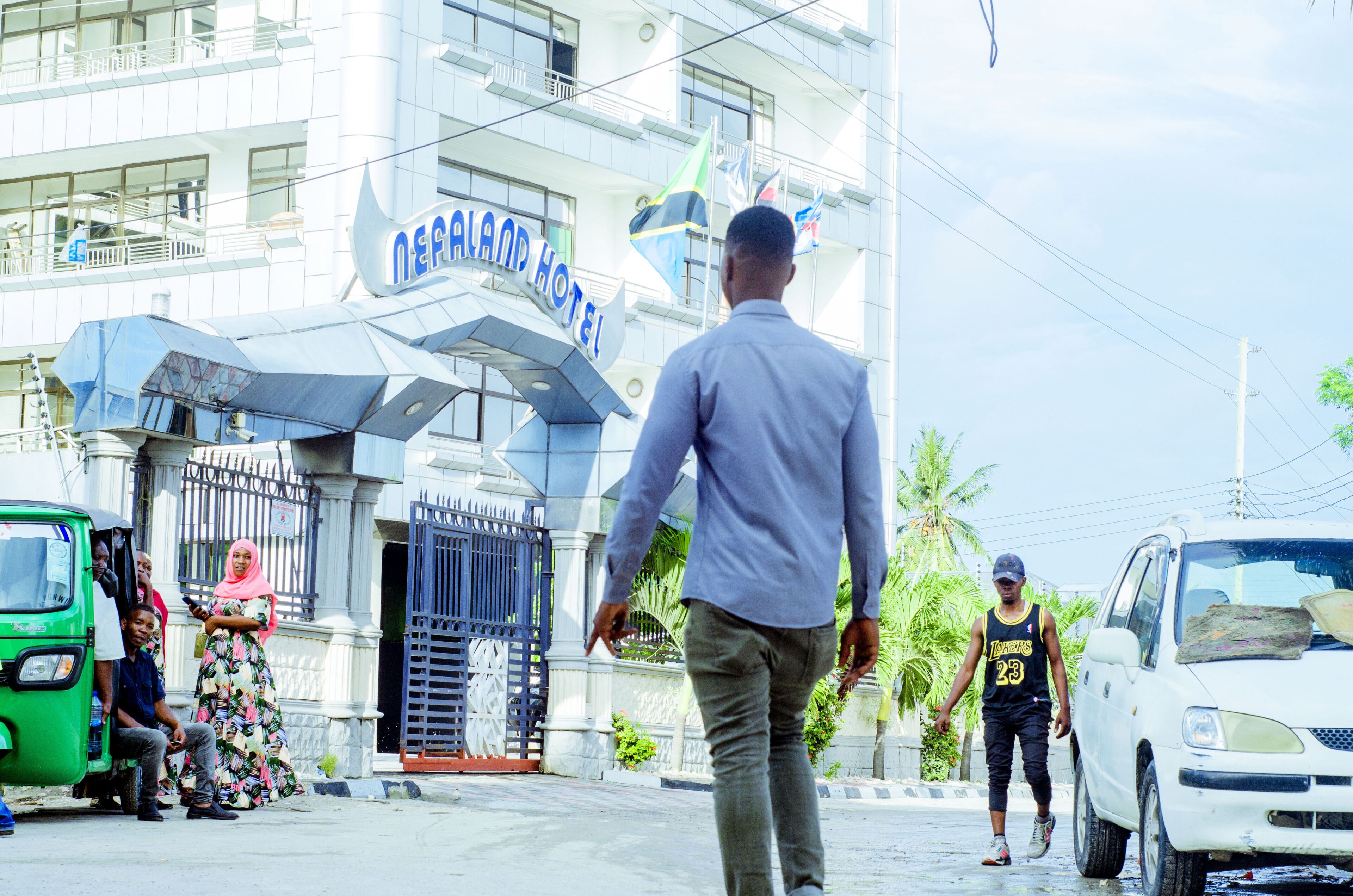 A hotel entrance with a sign reading "NEFFALAND HOTEL".