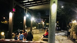 A covered outdoor area with stone benches and a central water feature. - Tu Wei 192 (Zhuangwei)