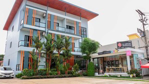 A multi-story building with a modern design, featuring balconies and a ground-level shop. - S2 Airport Residence (Sa Khu)