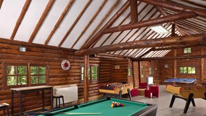 A log cabin with a pool table, foosball table, and a billiards table. - Hôtel Centre Port-Royal (Saint-Lambert)