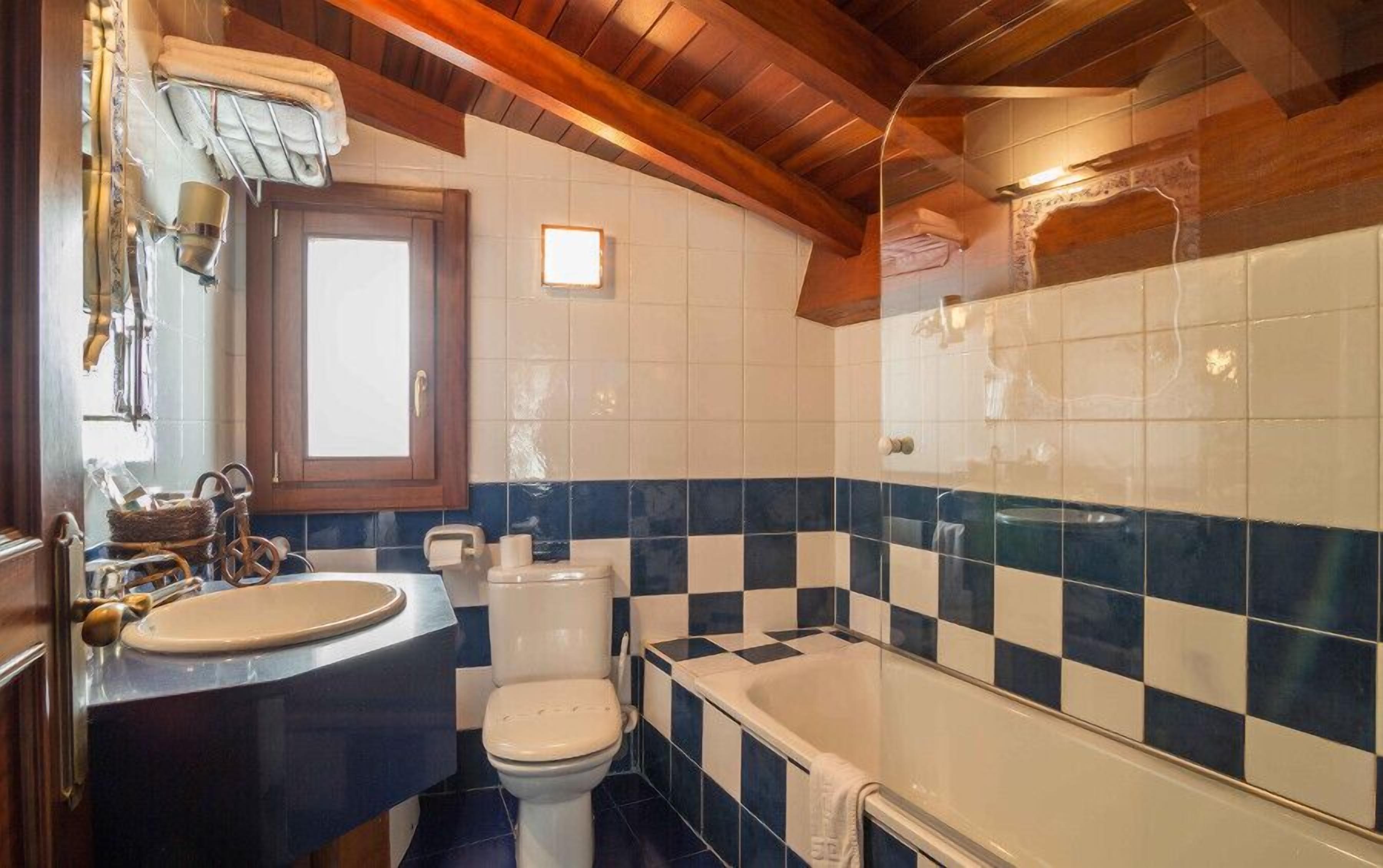A bathroom with a sink, toilet, and bathtub.