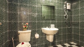 A bathroom with a toilet, sink, and shower. - Modern Resort at Naiyang (Sa Khu)