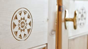 A wooden door with a geometric pattern and a brass handle.
