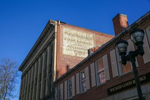 A building with a large sign advertising a store named 'Tompkins Fine Apparel, Clothing, Accessories'. - The Hotel Salem (Salem)