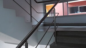 A staircase with metal railings and a window at the top. - Cypa Hotel (Abidjan)