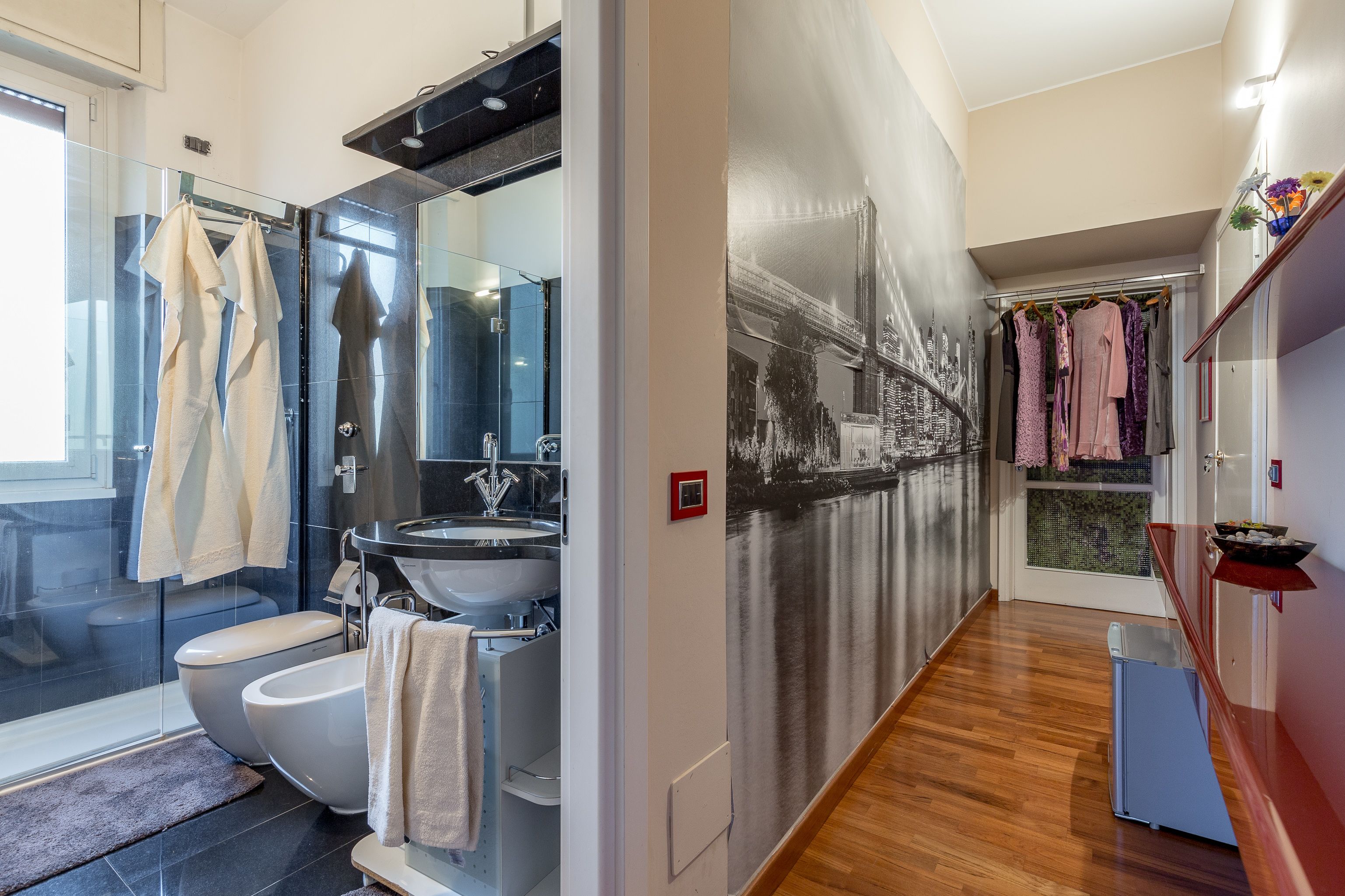 Un baño moderno con ducha de vidrio, inodoro blanco y lavamanos.