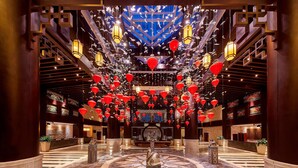 A spacious lobby with a central staircase, decorative lanterns, and a patterned floor. - Four Points By Sheraton Danzhou (Danzhou)
