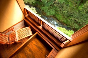 A wooden deck with a view of a river and greenery. - Moritaya (Koriyama)