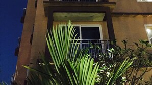 A building with a neon sign for 'David's' and a 'Grand Opening' banner. - David Residence (Mai Khao)
