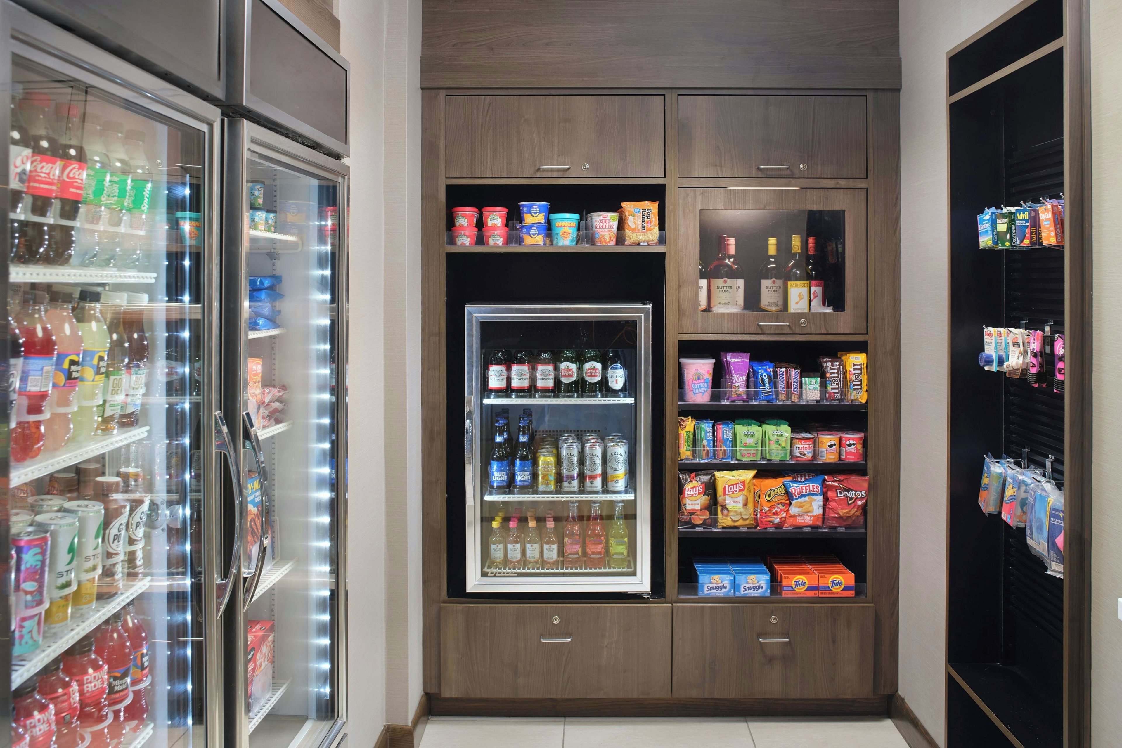 A refrigerated display case with various beverages and snacks.
