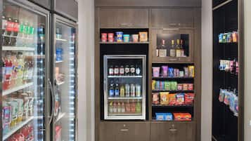 A refrigerated display case with various beverages and snacks.