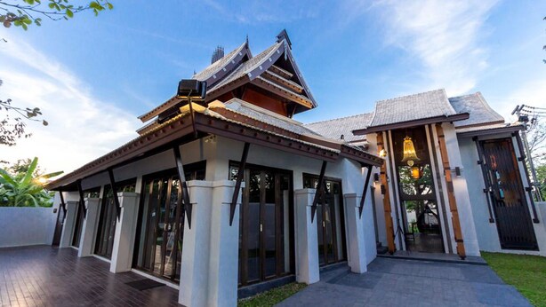 A traditional Japanese-style building with a sloped roof, large glass doors, and a wooden deck. - Jamadevi Hotel (Lamphun)