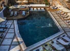 Seasonal outdoor pool, a waterfall pool, pool umbrellas, sun loungers