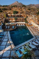 Seasonal outdoor pool, a waterfall pool, pool umbrellas, sun loungers