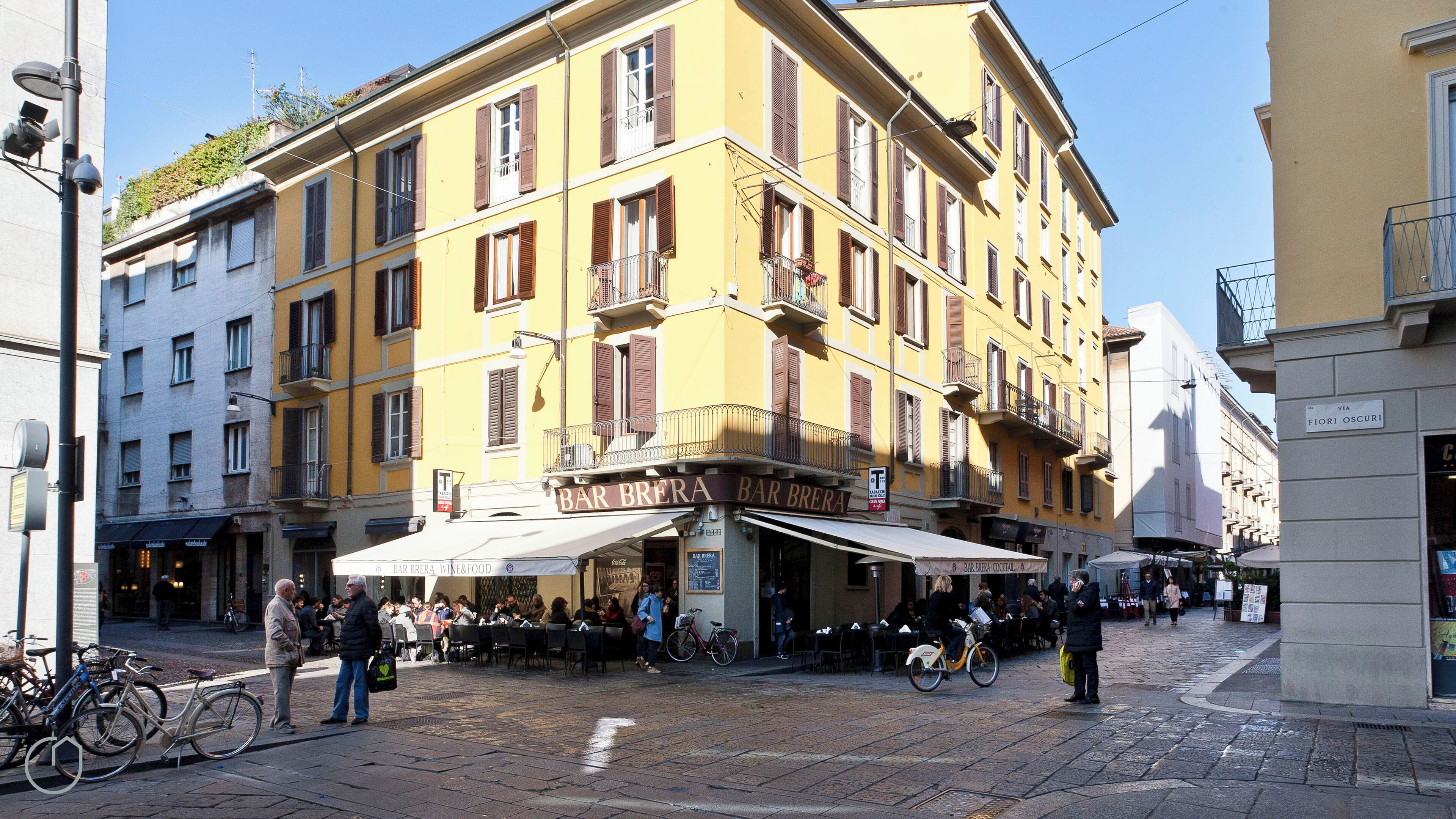A yellow building with a bar named Bar Brera.