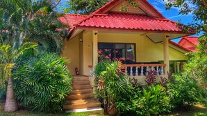 A house with a red roof, a covered porch, and a staircase leading to the entrance. - Chor Chang Villa Resort (Koh Samui)