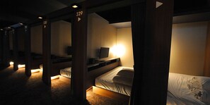 A hotel room with bunk beds, a television, and a small desk. - Cabinhouse Yado Fujinomiyaten (Fujinomiya)