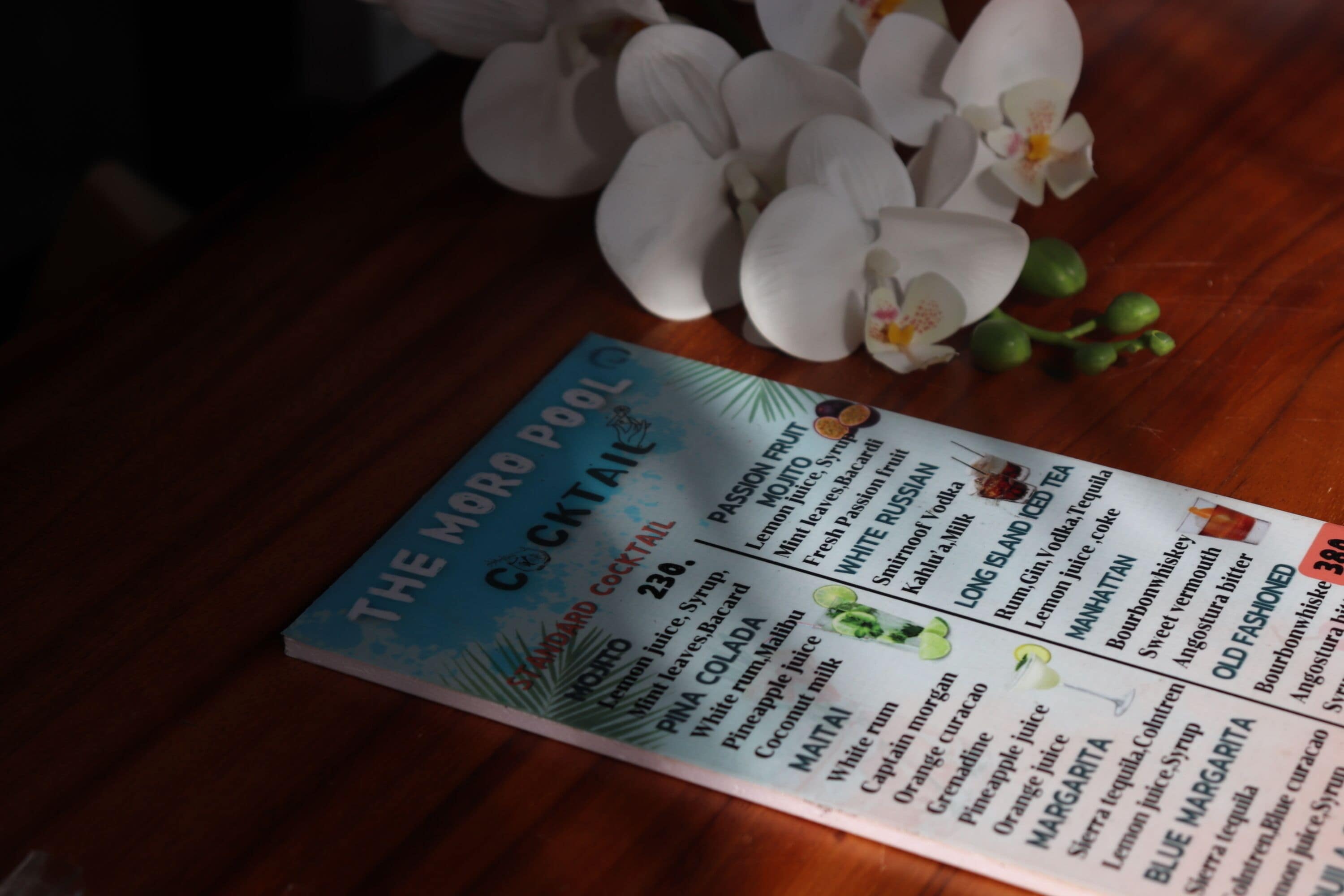 A cocktail menu with various drink options and prices.