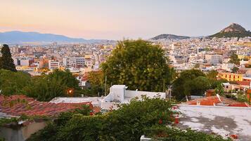 A cityscape with a prominent hill in the background, likely a historical or significant landmark.