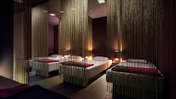 A modern hotel room with a large bed, two bedside tables, and a mirror.
