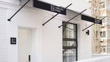 A modern building with a sign for Cendre Hotel.