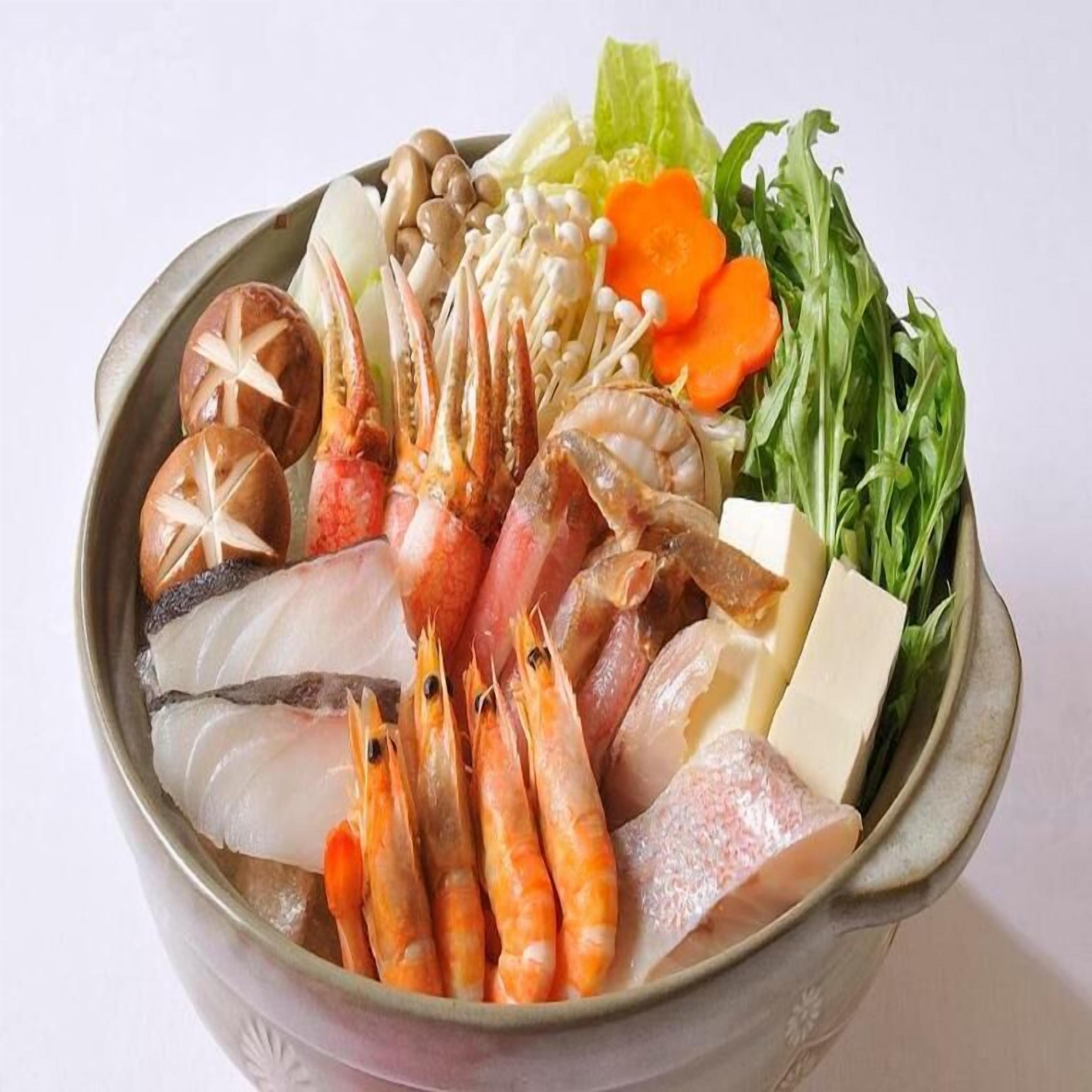 A bowl containing various seafood and vegetables.