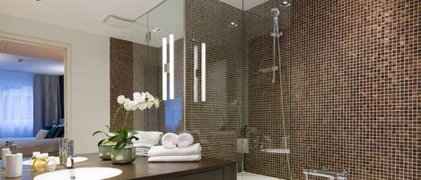 A modern bathroom with a large mirror, a sink, a bathtub, and a shower.