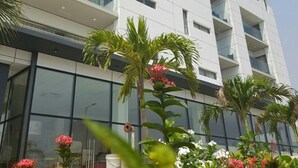 A modern multi-story building with balconies and large windows. - Suncity Apartments Hotel (Accra)
