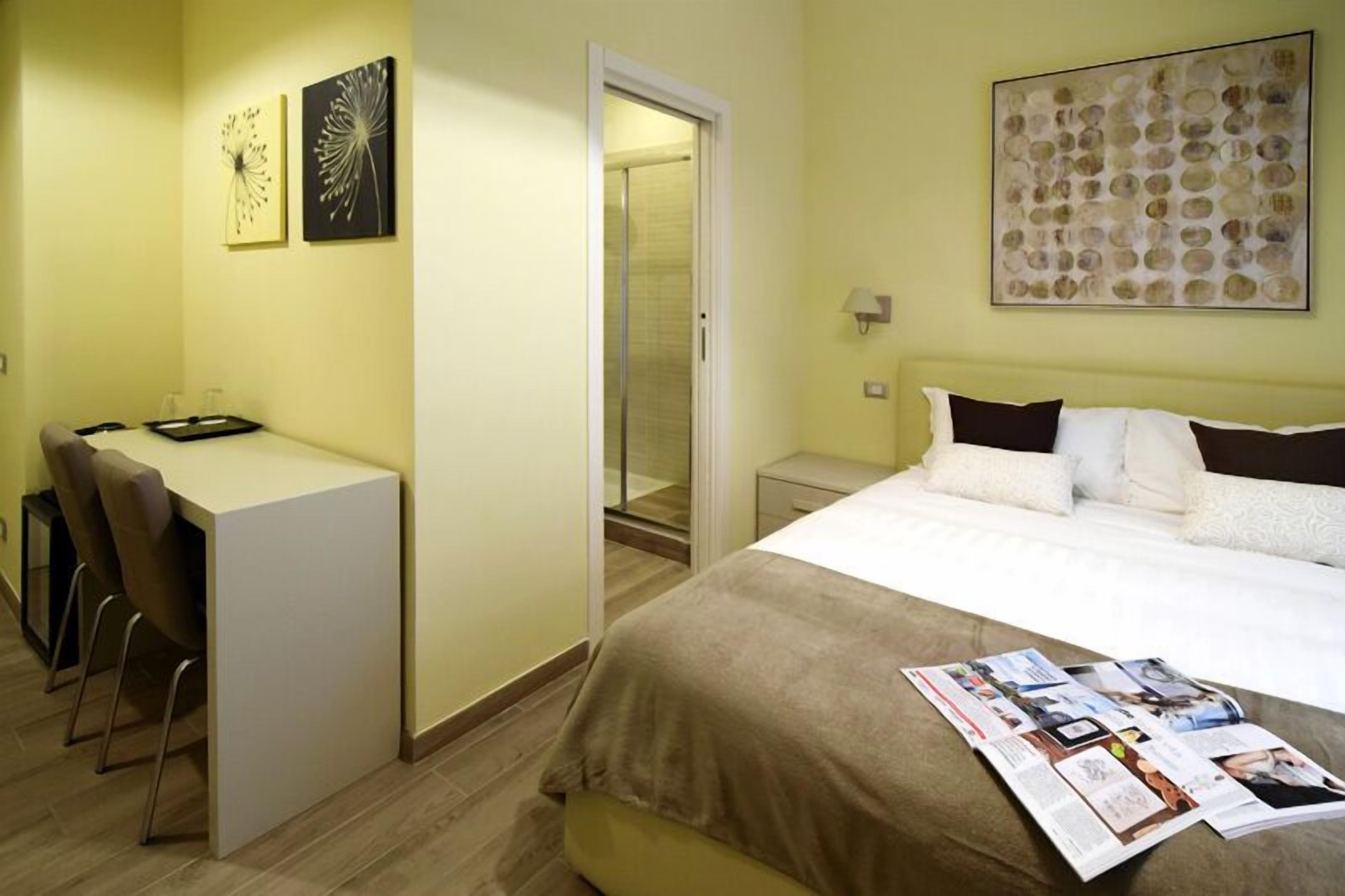 Ein Hotelzimmer mit einem Bett, einem Schreibtisch und Stühlen.