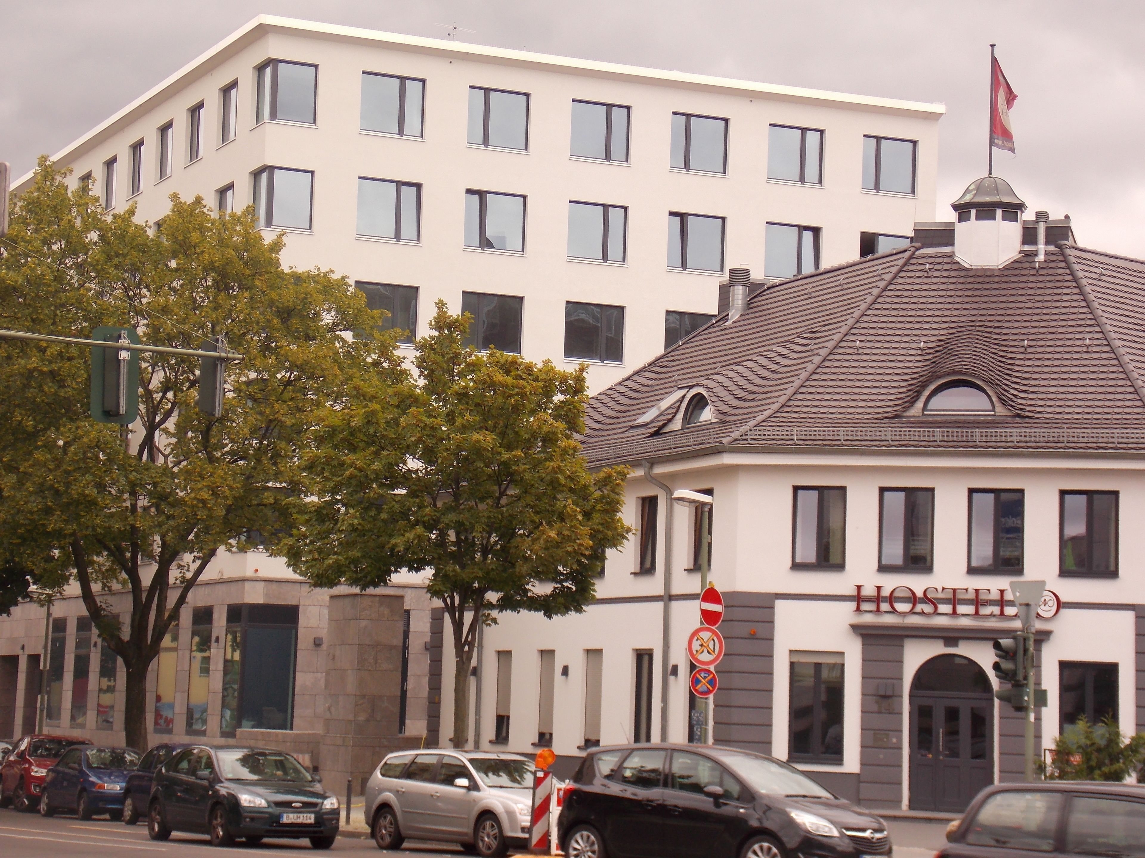 A building with a sign that reads "HOSTEL" indicating it is a hostel.
