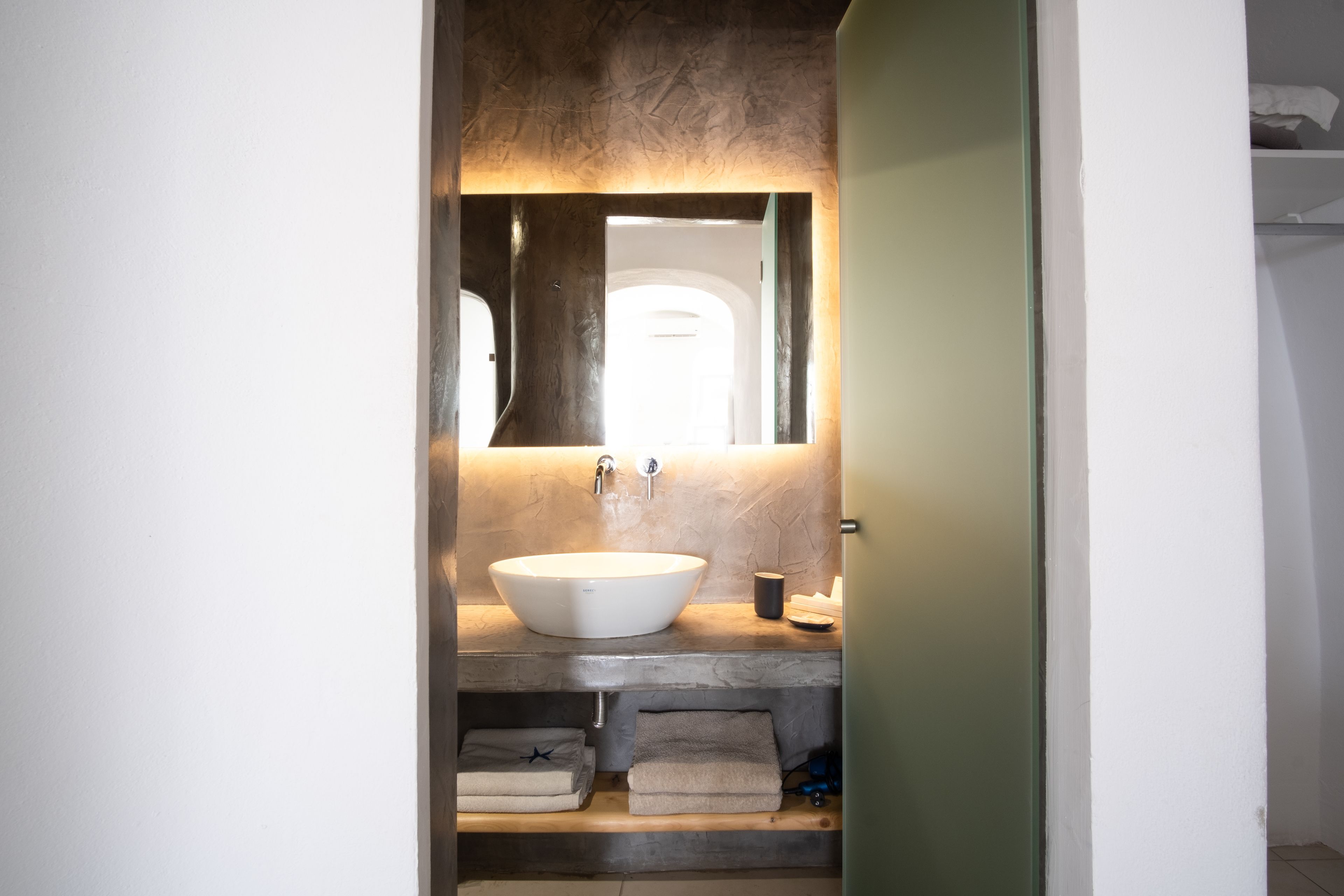 superior suite with caldera view and private jacuzzi | bathroom | shower, rainfall showerhead, designer toiletries, hair dryer