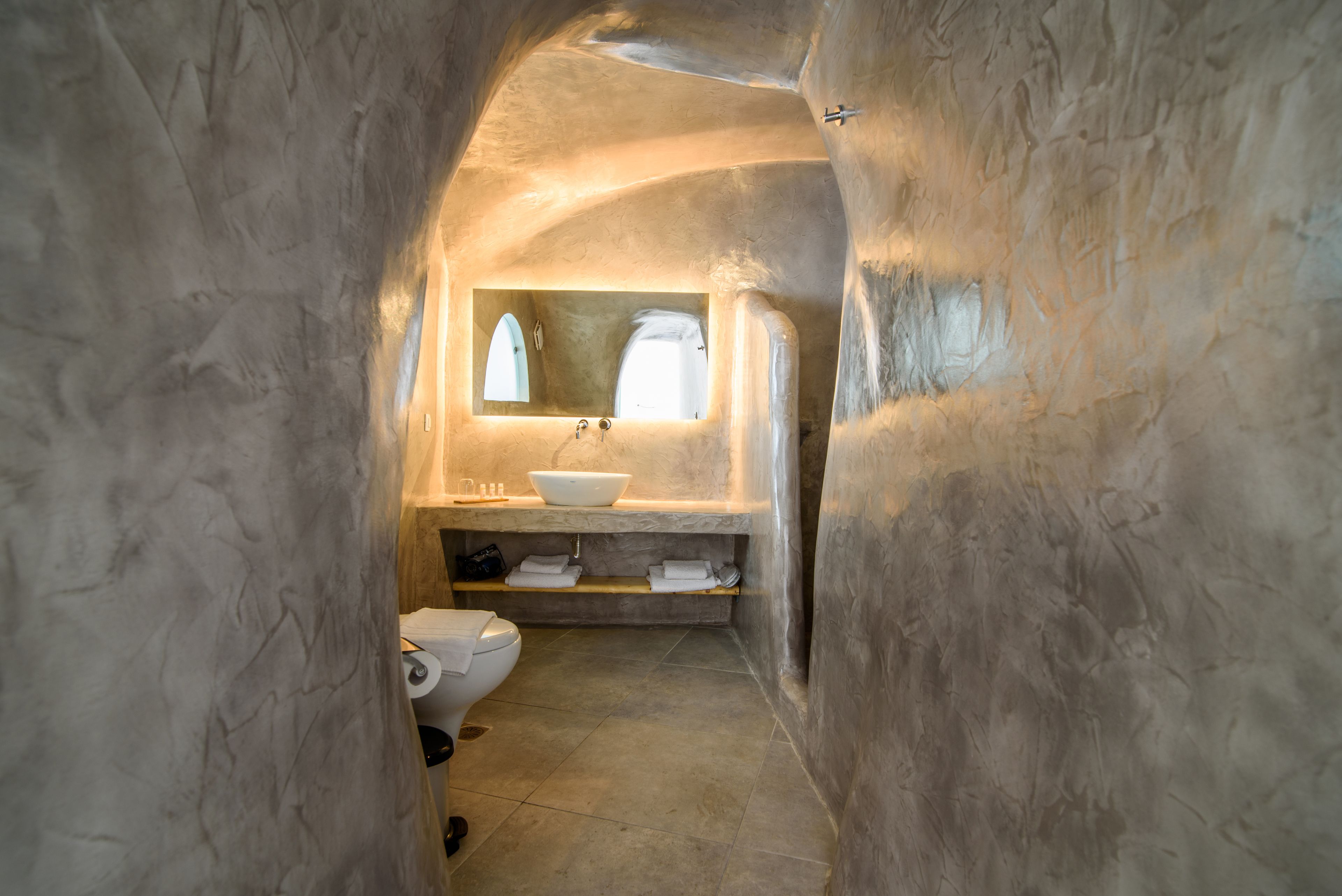 family suite with caldera view and private jacuzzi | bathroom | shower, rainfall showerhead, designer toiletries, hair dryer