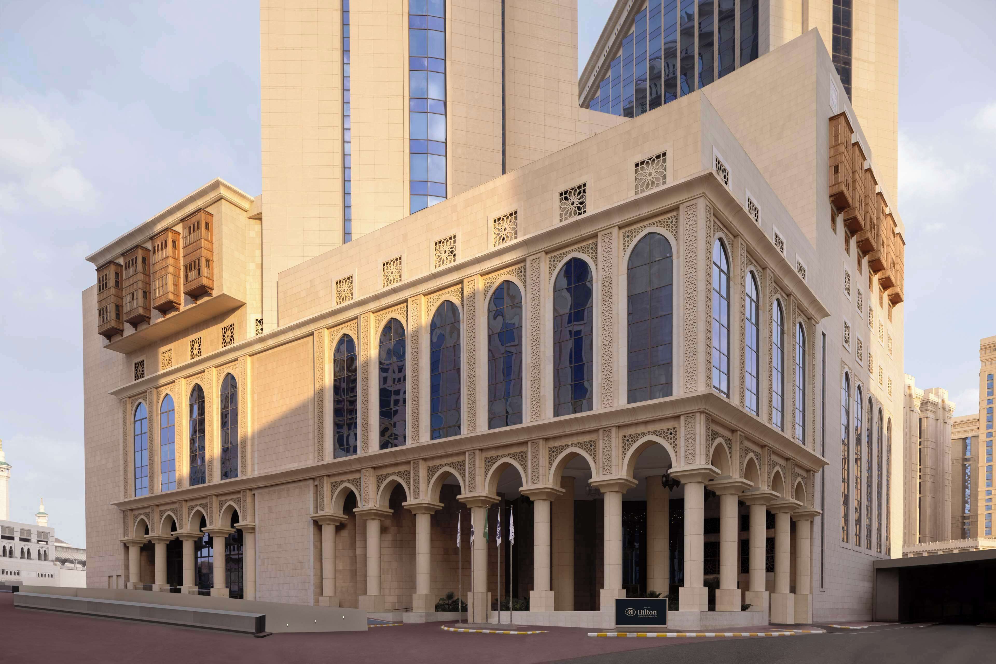 A large, historic building with arched windows and columns, likely a hotel or public building.