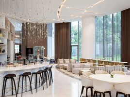 Un interior moderno con una zona de bar, asientos y ventanas amplias.