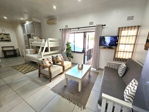 Deluxe Family Apartment with Balcony, Courtyard View, 1 Bedroom | Living area | 41-inch Smart TV with satellite channels, TV, Netflix - Leopard Tree Lodge (St. Lucia)