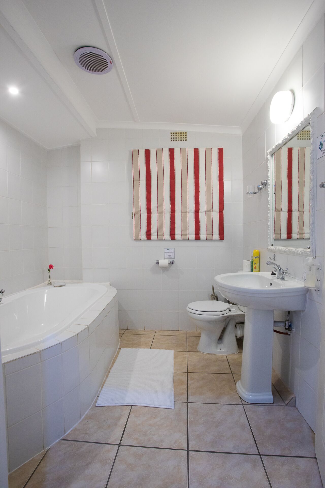 A modern bathroom with a bathtub, toilet, and sink.