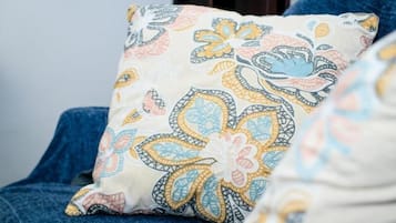 A pillow with a floral pattern on a chair.